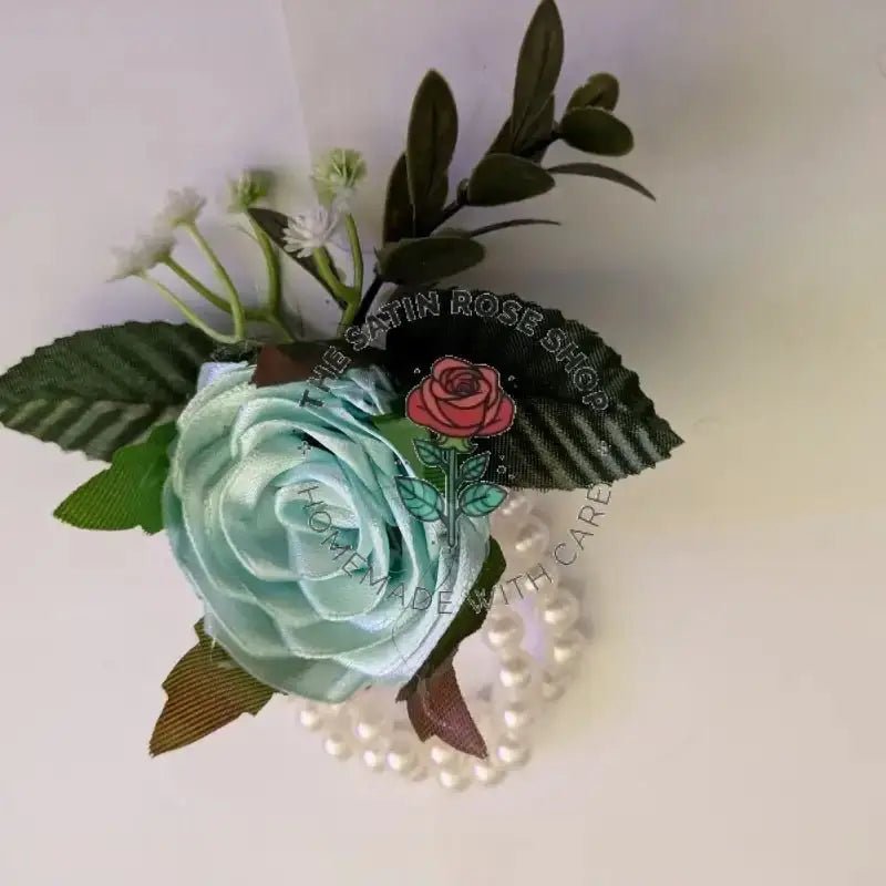 Handmade Aqua Satin Rose Corsages with green leaves and white accent flowers by The Satin Rose Shop