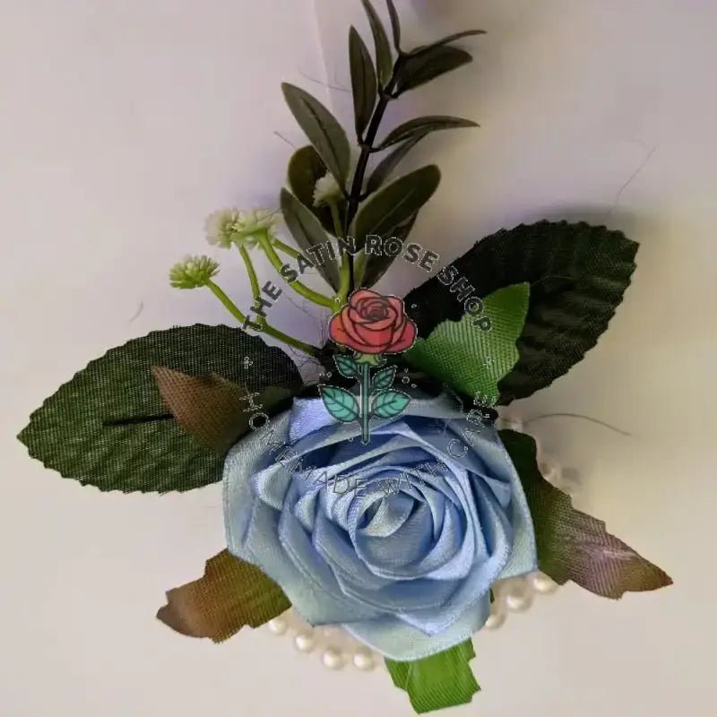 Handmade Bluebird Satin Rose Corsages with light blue satin rose and green leaves by The Satin Rose Shop