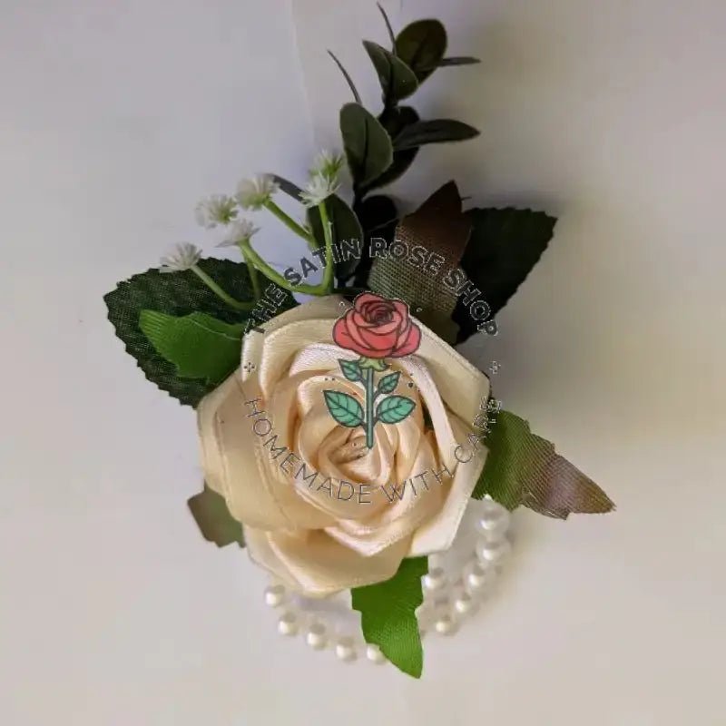 Handmade Cream Satin Rose Corsages with green leaves and white pearl accents from The Satin Rose Shop