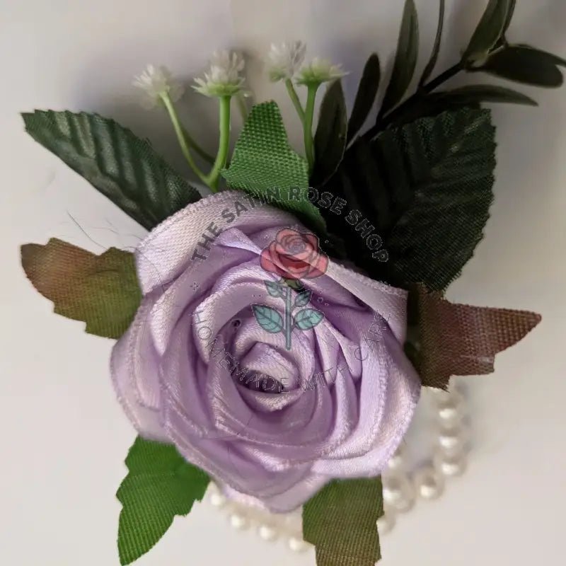 Handmade Light Orchid Satin Rose Corsages with green leaves and white pearl accents from The Satin Rose Shop