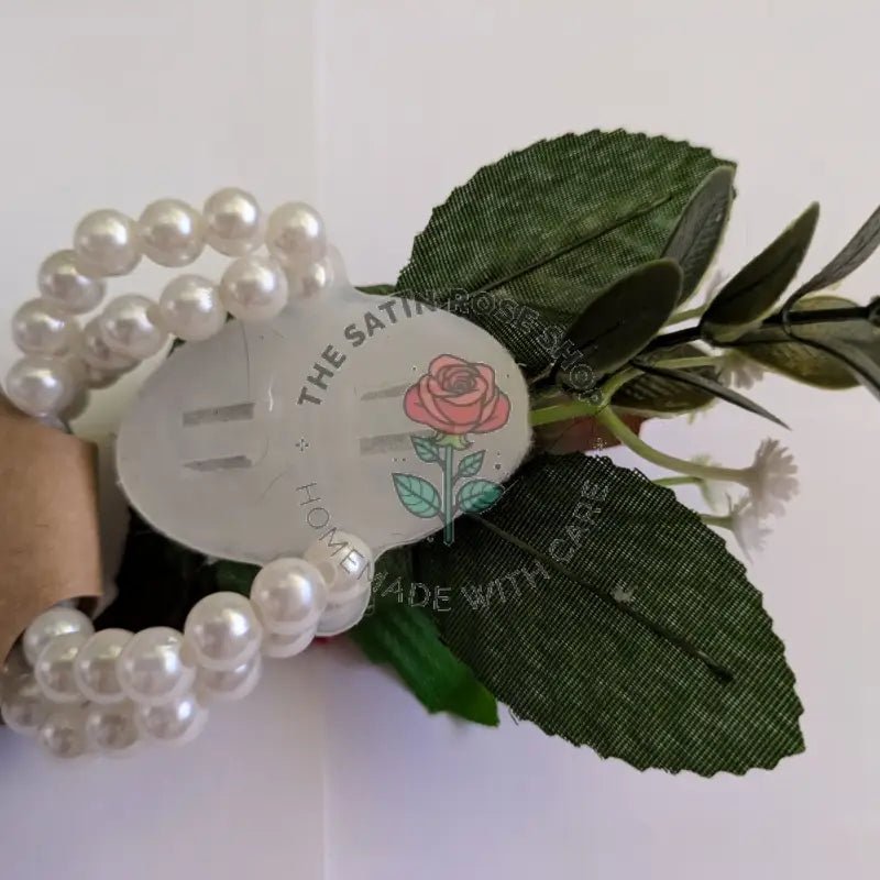 Handmade purple satin rose corsages with green leaves and pearl bracelet from The Satin Rose Shop