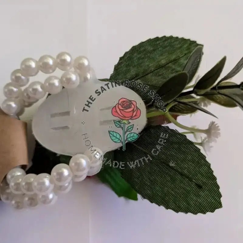 Handmade Red Satin Rose Corsages with green leaves and pearl bracelet detail from The Satin Rose Shop