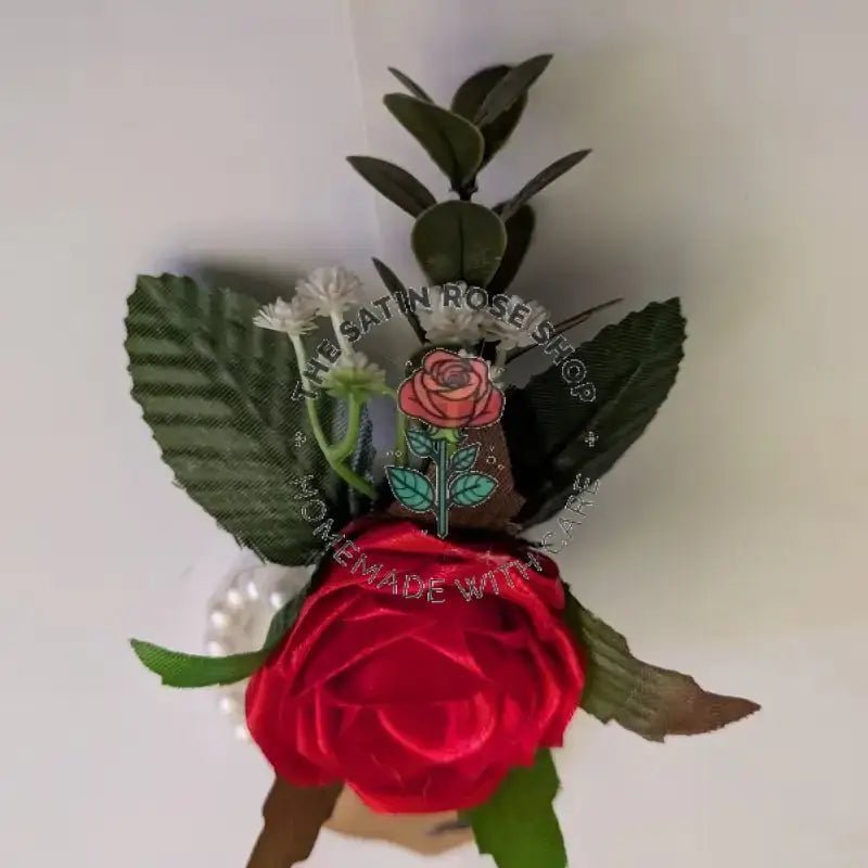 Handmade Red Satin Rose Corsages with green leaves and white accent flowers from The Satin Rose Shop